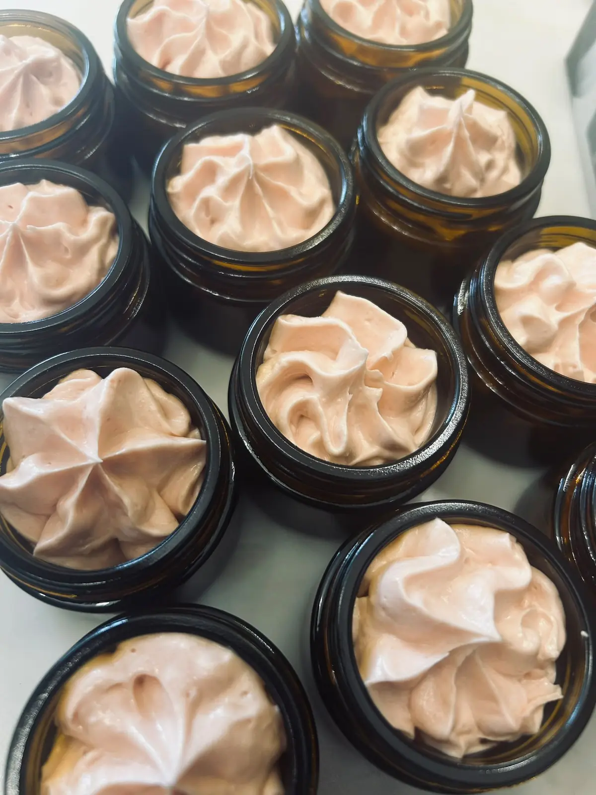 Amber jars filled with freshly whipped pink balm